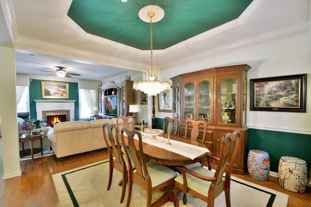 a view of a dining room with furniture and chandelier
