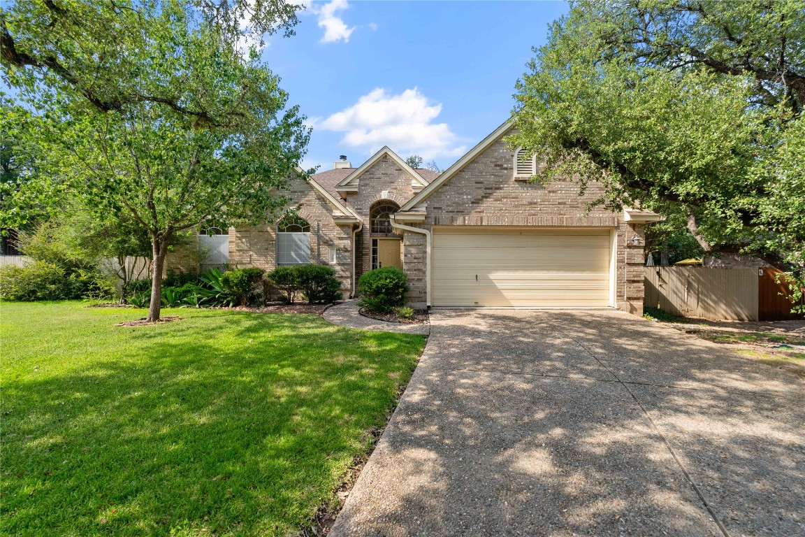 Beautiful curb appeal with mature trees and native plants