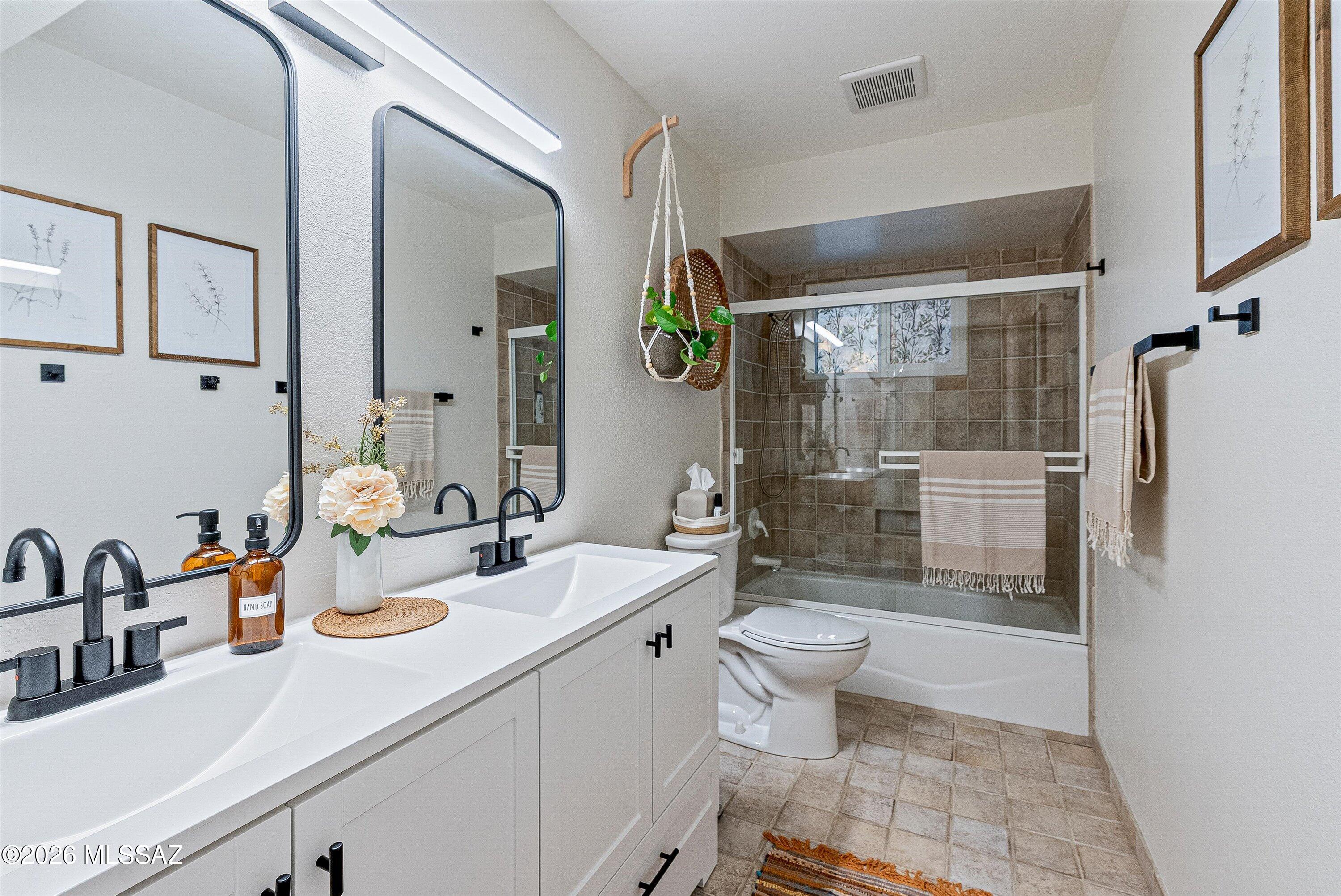 3949 West Mars Street Tucson, AZ 85741 - Photo 19 of 27 a bathroom with a sink a toilet and shower