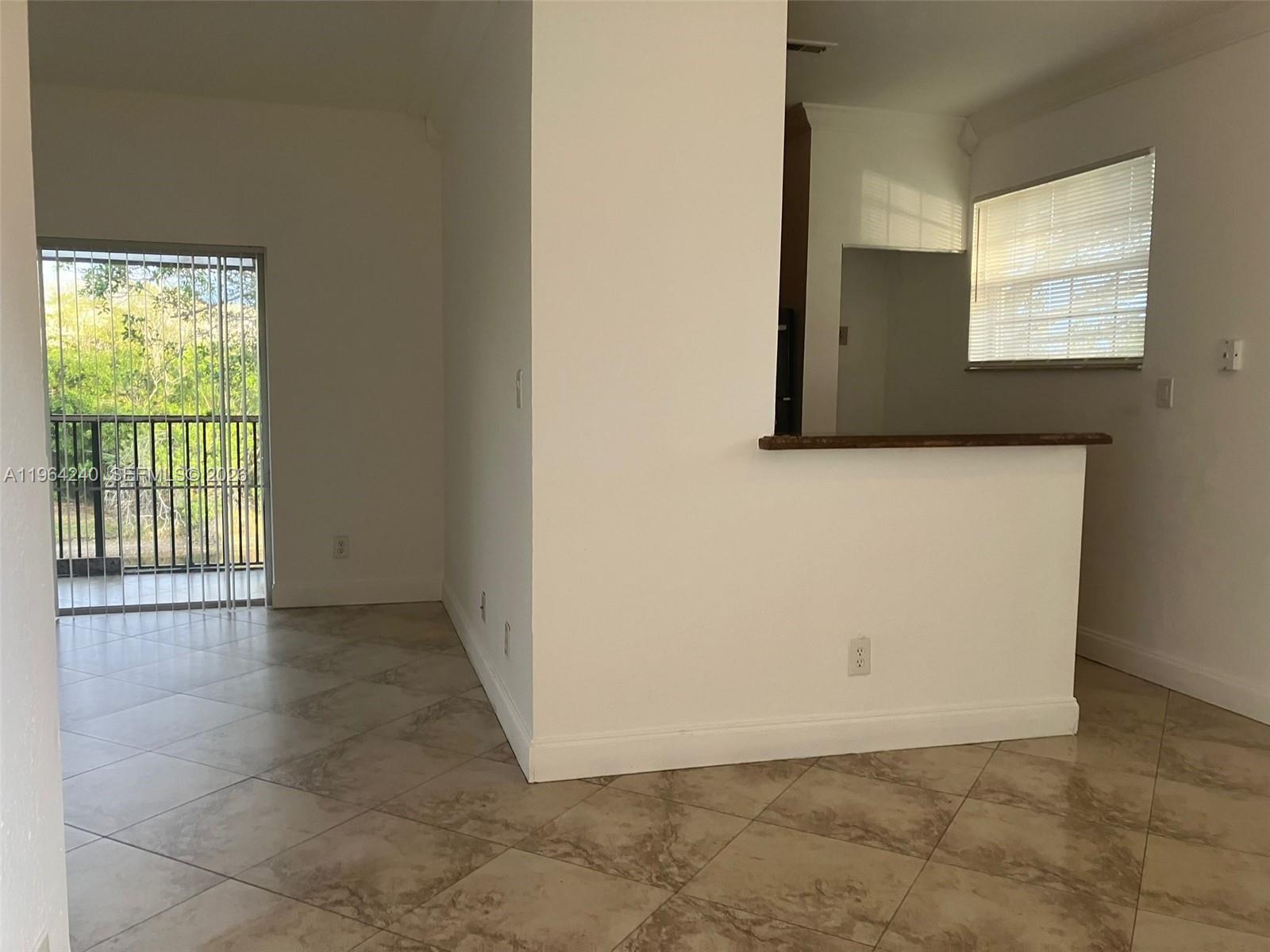 620 Cypress Club Way, Unit L13 Deerfield Beach, FL 33064 - Photo 3 of 14 a view of an empty room with a window