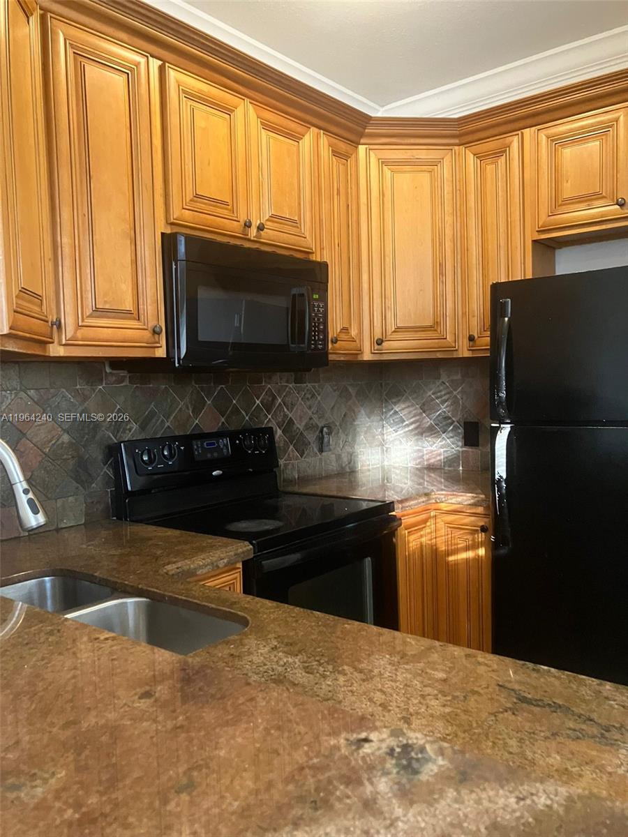 620 Cypress Club Way, Unit L13 Deerfield Beach, FL 33064 - Photo 4 of 14 a kitchen with granite countertop a refrigerator a stove a sink and dishwasher