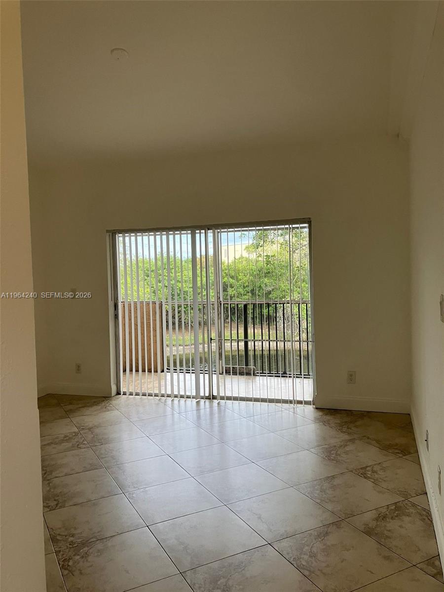 620 Cypress Club Way, Unit L13 Deerfield Beach, FL 33064 - Photo 6 of 14 a view of an empty room with a balcony