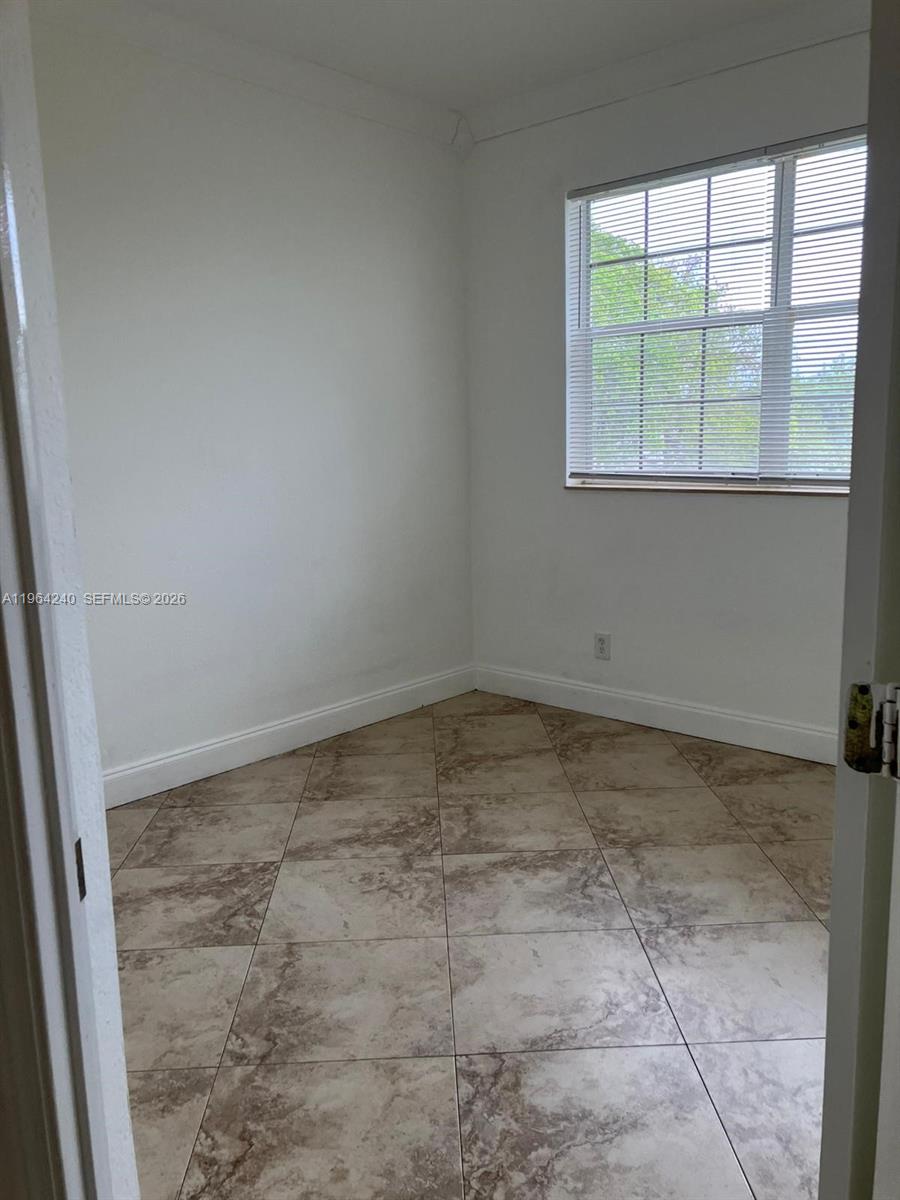 620 Cypress Club Way, Unit L13 Deerfield Beach, FL 33064 - Photo 7 of 14 an empty room with a empty space and window