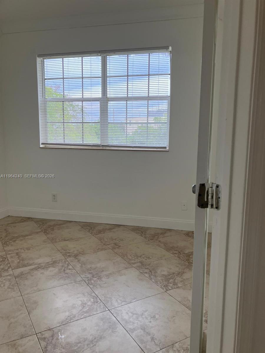 620 Cypress Club Way, Unit L13 Deerfield Beach, FL 33064 - Photo 8 of 14 a view of an empty room with a window