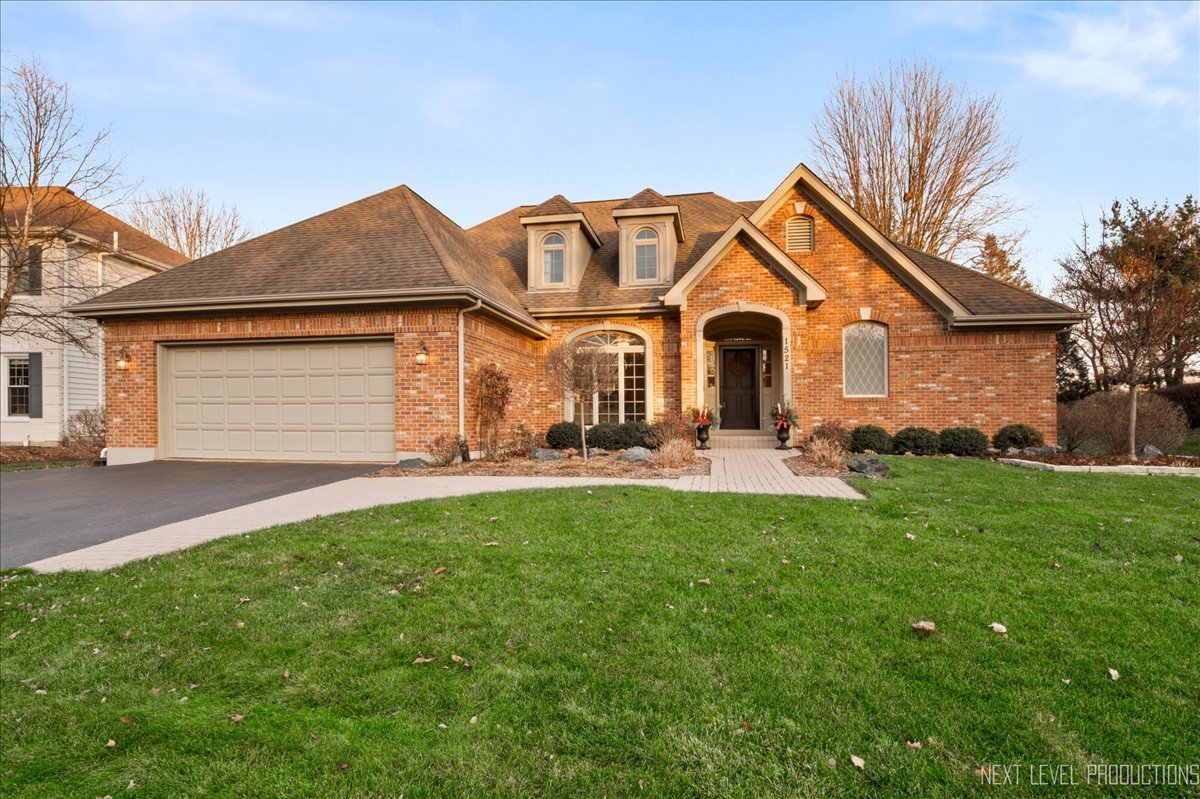 a front view of a house with yard and green space