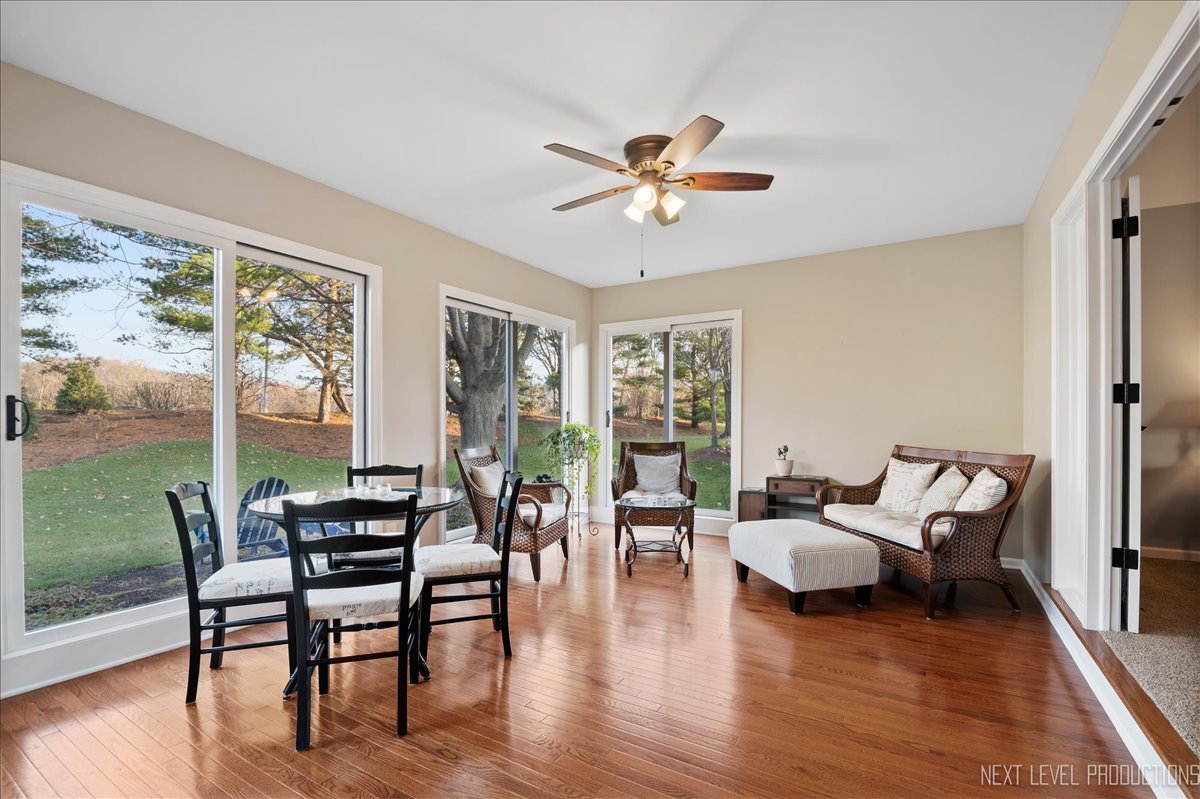 1521 Eagle Brook Drive Geneva, IL 60134 - Photo 11 of 41 a living room with furniture floor to ceiling window and wooden floor