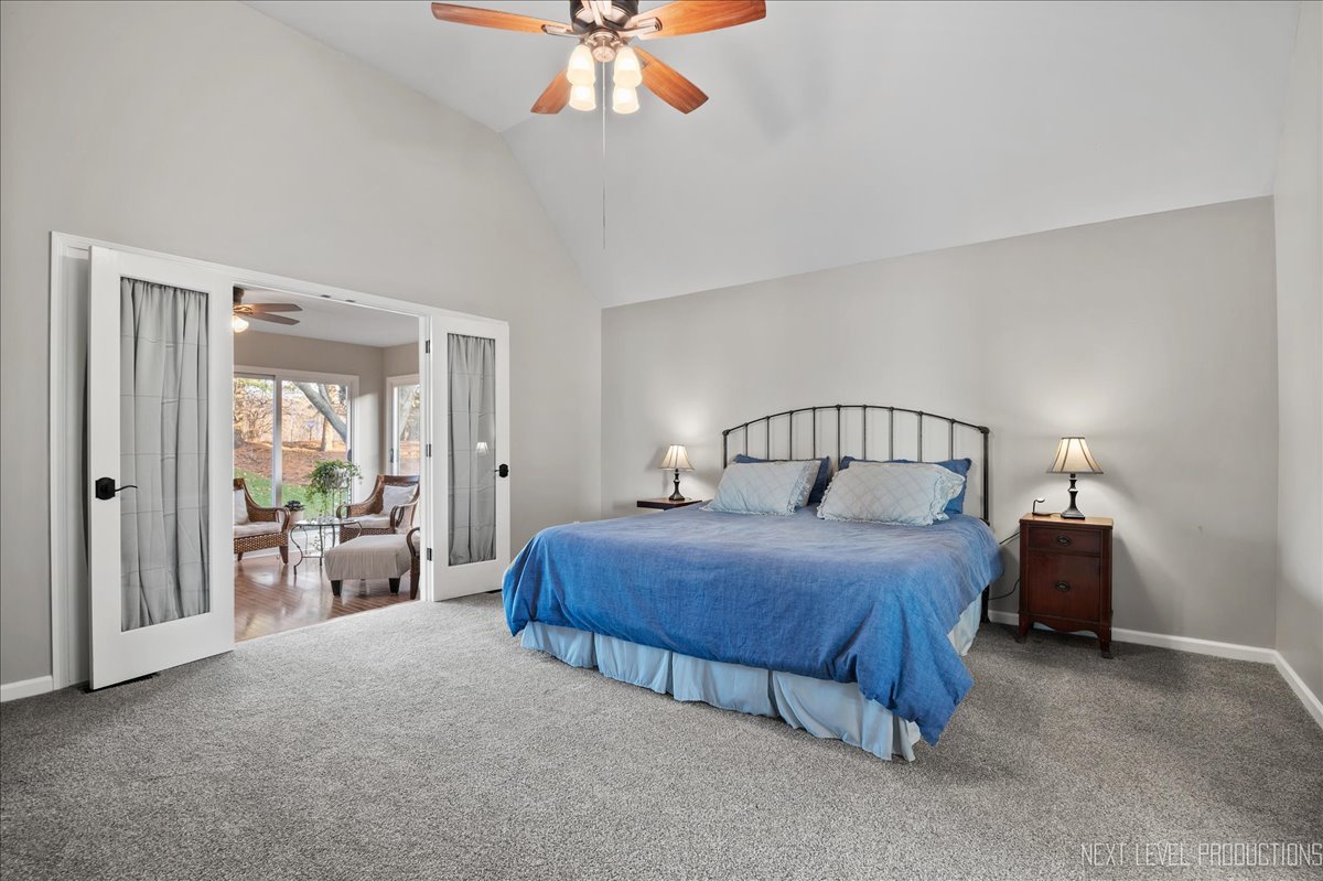 1521 Eagle Brook Drive Geneva, IL 60134 - Photo 20 of 41 a bedroom with bed and a chandelier