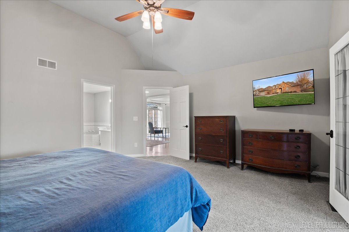1521 Eagle Brook Drive Geneva, IL 60134 - Photo 21 of 41 a bedroom with a bed and a flat screen tv