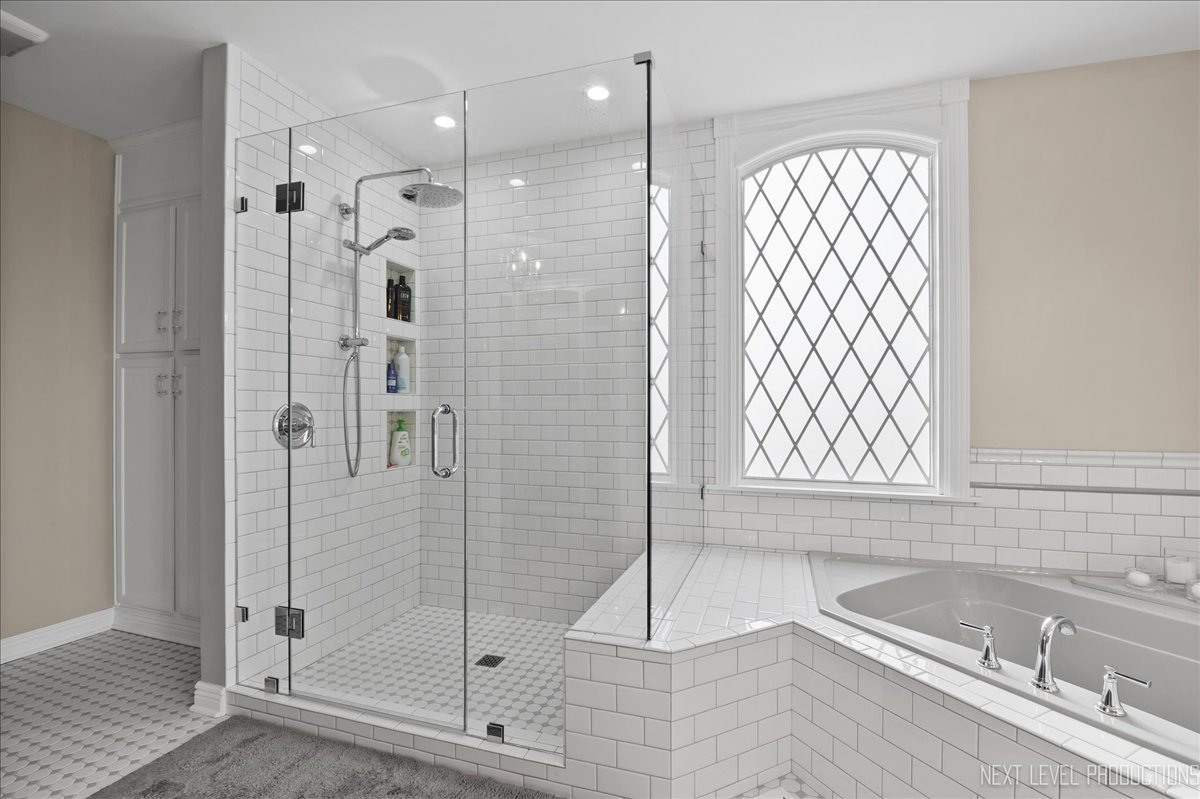 1521 Eagle Brook Drive Geneva, IL 60134 - Photo 23 of 41 a bathroom with a bathtub and a shower