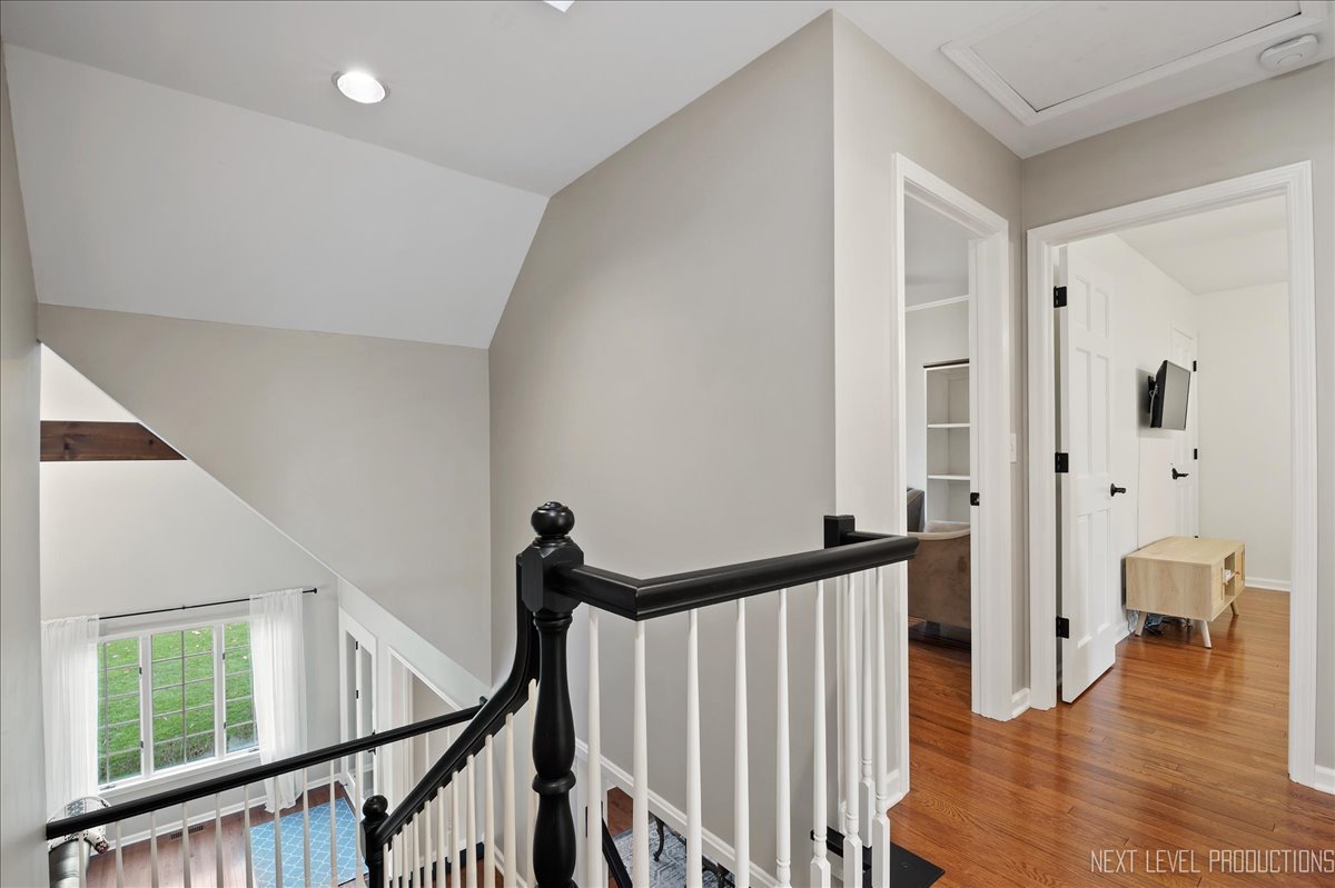 1521 Eagle Brook Drive Geneva, IL 60134 - Photo 27 of 41 a view of a hallway with wooden floor and stairs