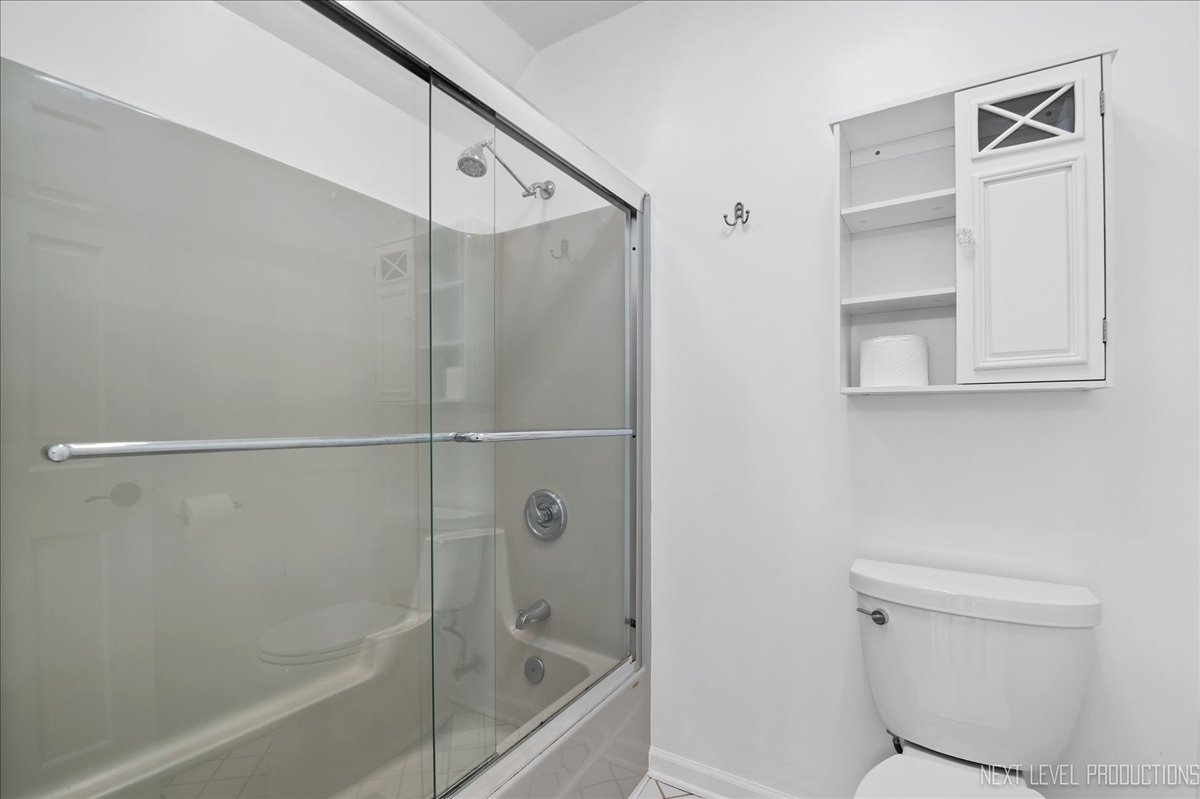 1521 Eagle Brook Drive Geneva, IL 60134 - Photo 33 of 41 a bathroom with a shower and a toilet