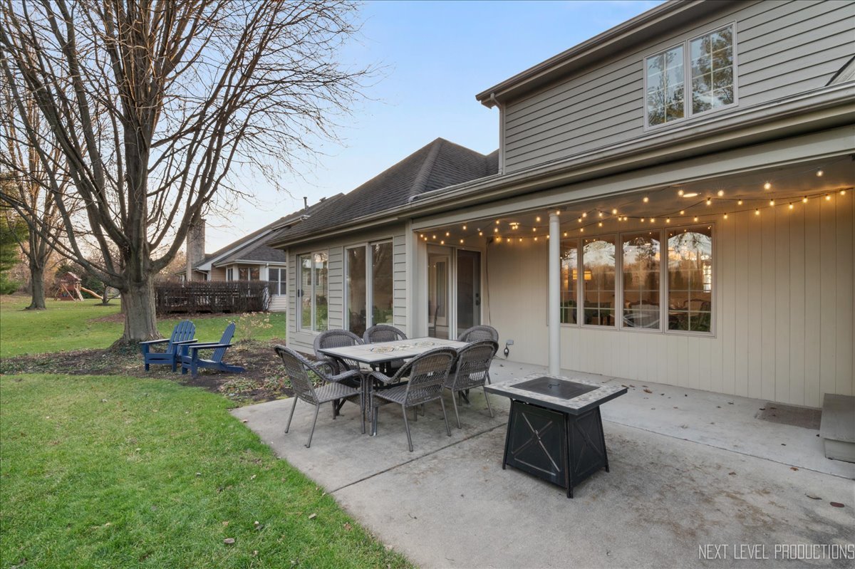 1521 Eagle Brook Drive Geneva, IL 60134 - Photo 40 of 41 a view of a patio with table and chairs and a barbeque