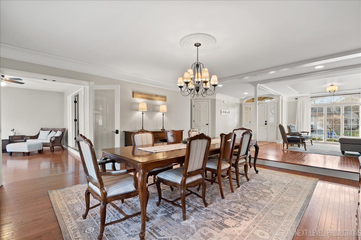 1521 Eagle Brook Drive Geneva, IL 60134 - Photo 9 of 41 a view of a dining room with furniture a chandelier and wooden floor
