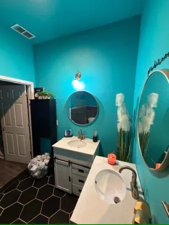 a bathroom with a sink mirror and toilet