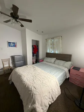 a bedroom with bed and window