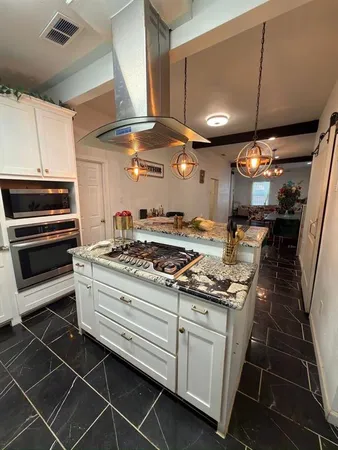 a stove top oven sitting inside of a kitchen