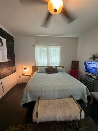 a bedroom with a bed and window