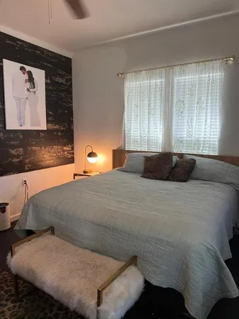 a bedroom with a bed and window