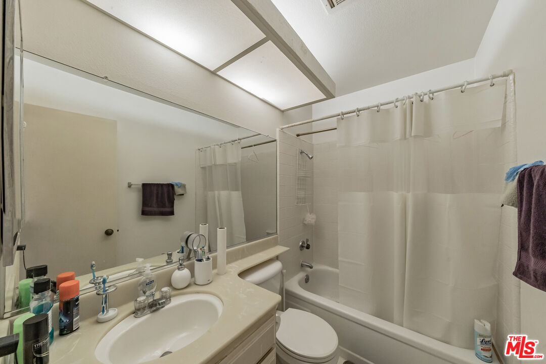 19127 Index Street, Unit 3 Porter Ranch, CA 91326 - Photo 11 of 18 a bathroom with a sink a toilet and shower