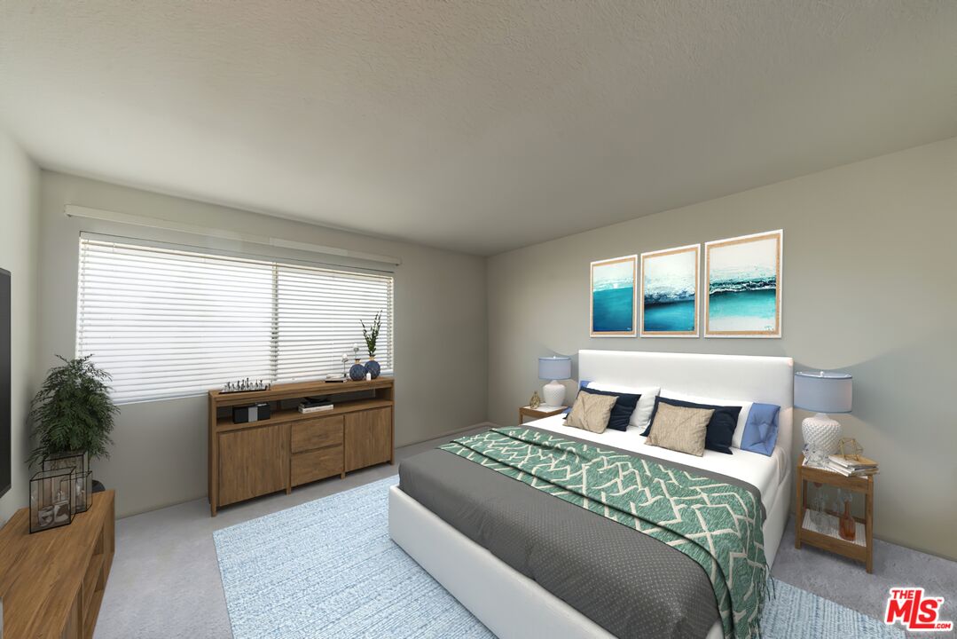 19127 Index Street, Unit 3 Porter Ranch, CA 91326 - Photo 2 of 18 a bedroom with a large bed and a potted plant