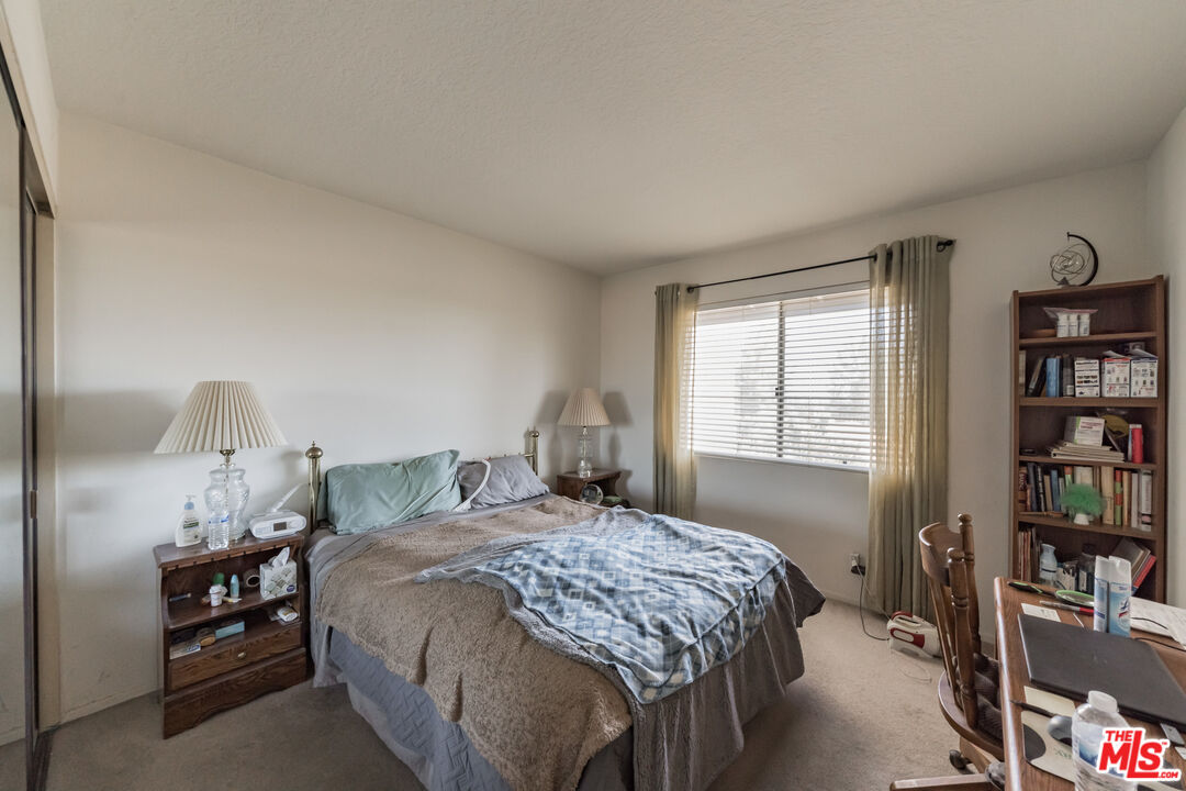 19127 Index Street, Unit 3 Porter Ranch, CA 91326 - Photo 9 of 18 a bedroom with a bed and a window