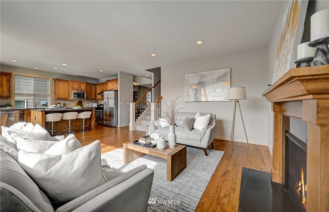 4022 167th Street Southeast Bothell, WA 98012 - Photo 14 of 34 a living room with furniture wooden floor and a kitchen view