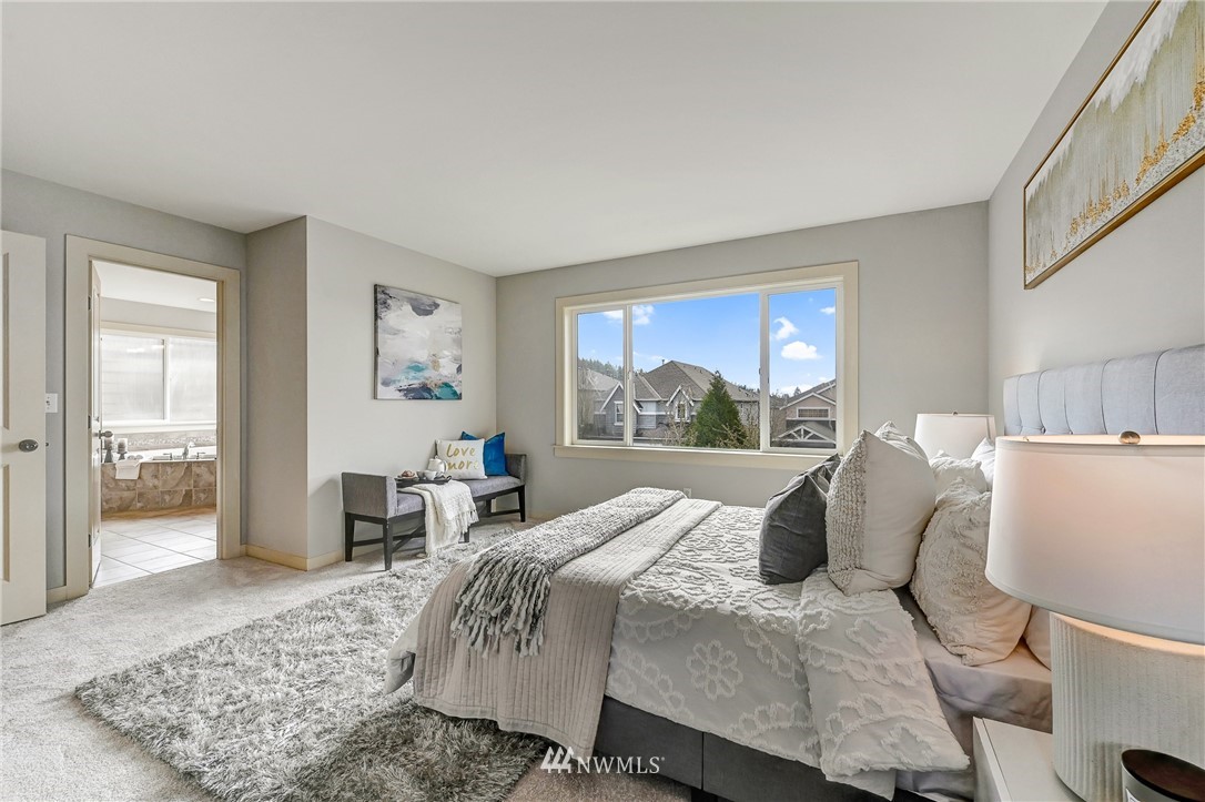 4022 167th Street Southeast Bothell, WA 98012 - Photo 19 of 34 a bedroom with a large bed and a window