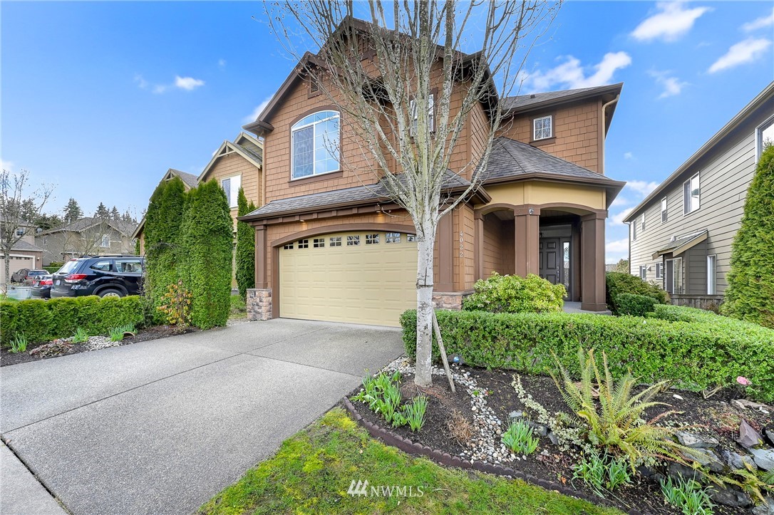 4022 167th Street Southeast Bothell, WA 98012 - Photo 2 of 34 a front view of a house with garden