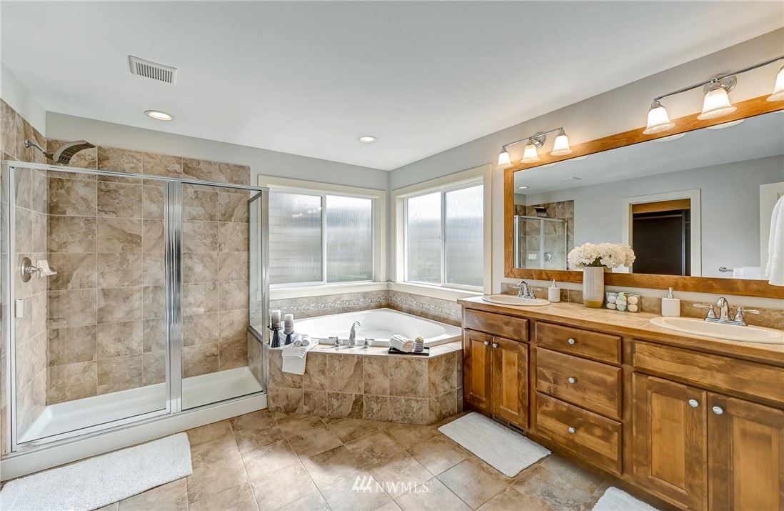 4022 167th Street Southeast Bothell, WA 98012 - Photo 22 of 34 a large bathroom with a tub sink shower and mirror