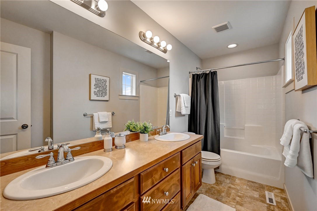 4022 167th Street Southeast Bothell, WA 98012 - Photo 28 of 34 a bathroom with a double vanity sink toilet mirror and bathtub