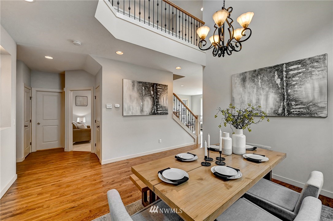 4022 167th Street Southeast Bothell, WA 98012 - Photo 7 of 34 a view of a dining room with furniture a chandelier and wooden floor