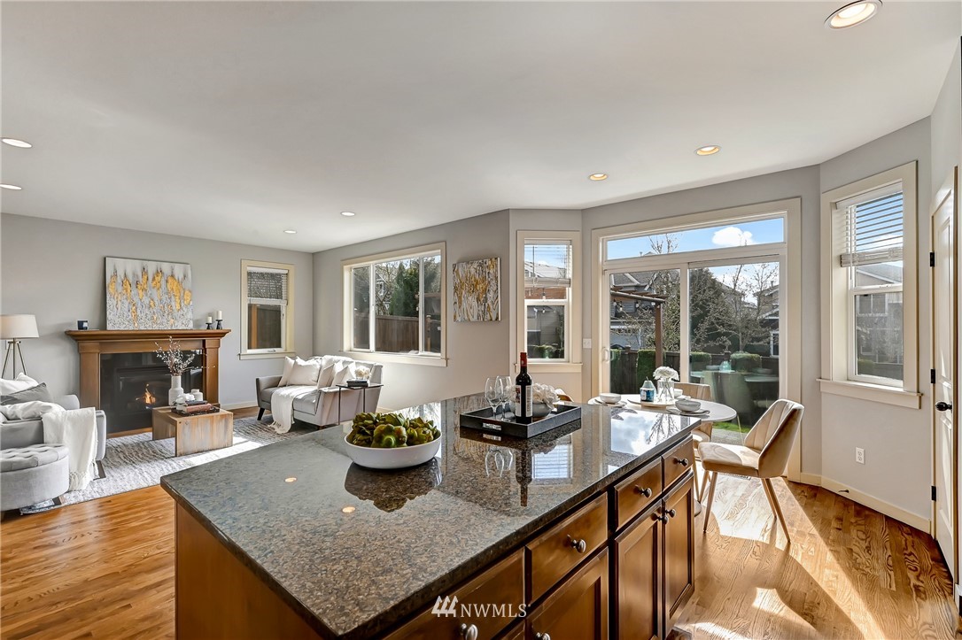 4022 167th Street Southeast Bothell, WA 98012 - Photo 10 of 34 a dining room with furniture a fireplace and wooden floor