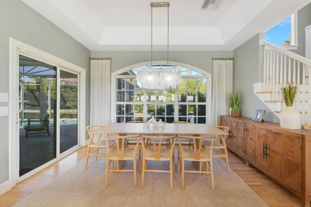 a view of a dining room with furniture large windows and wooden floor