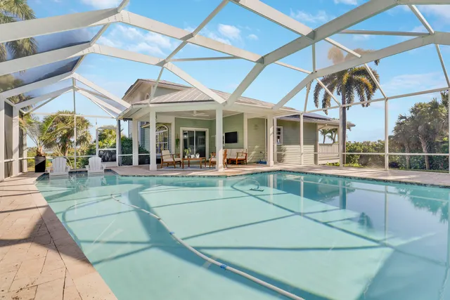 a backyard of a house with table and chairs