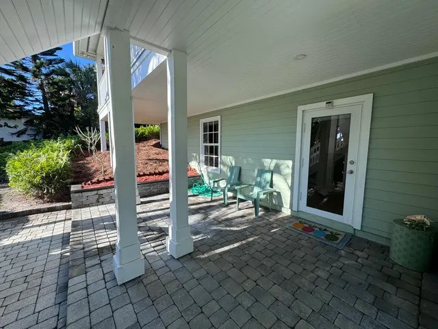 a view of a house with backyard porch and sitting area