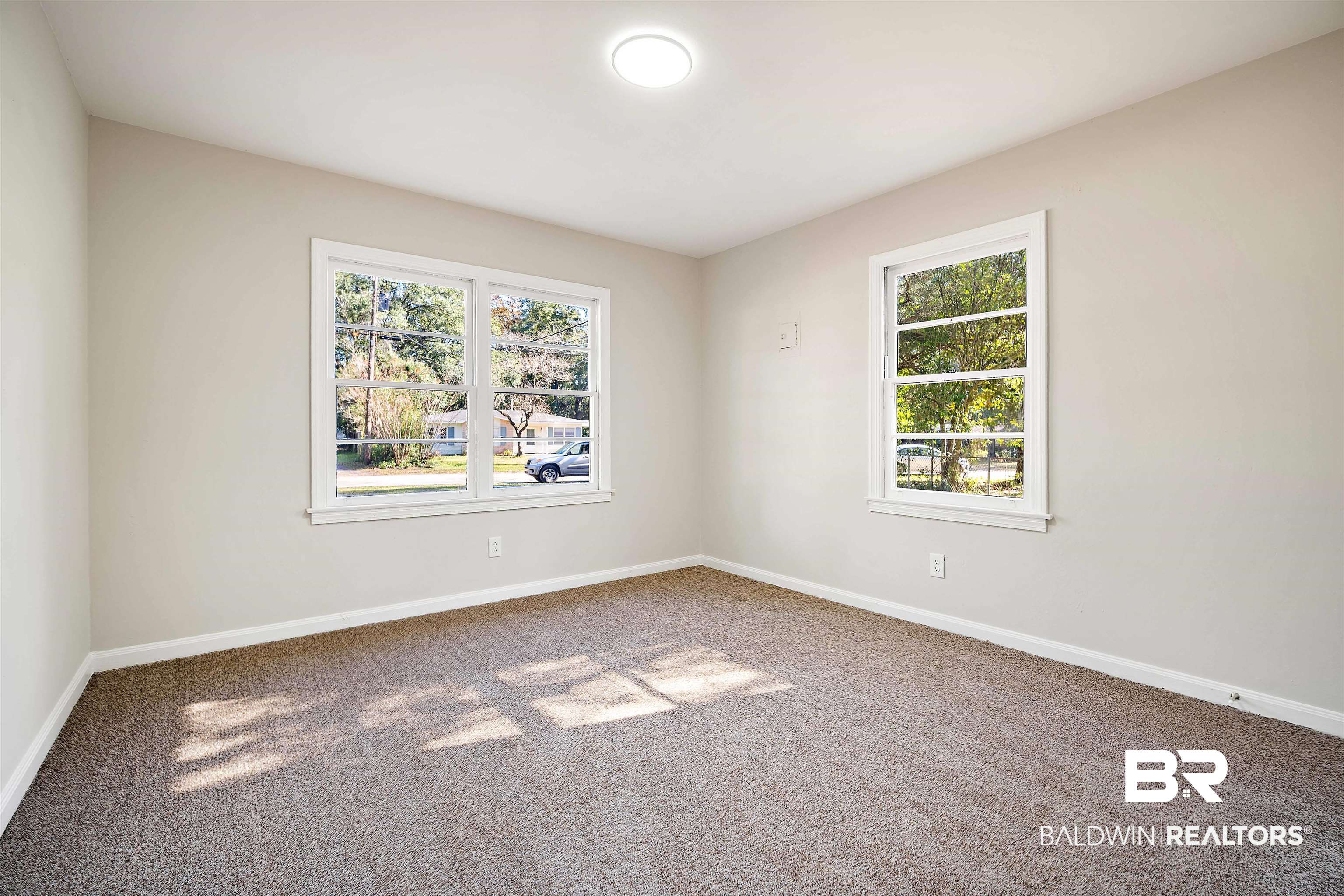 662 Merritt Drive Mobile, AL 36609 - Photo 13 of 21 Empty room with carpet flooring and plenty of natural light