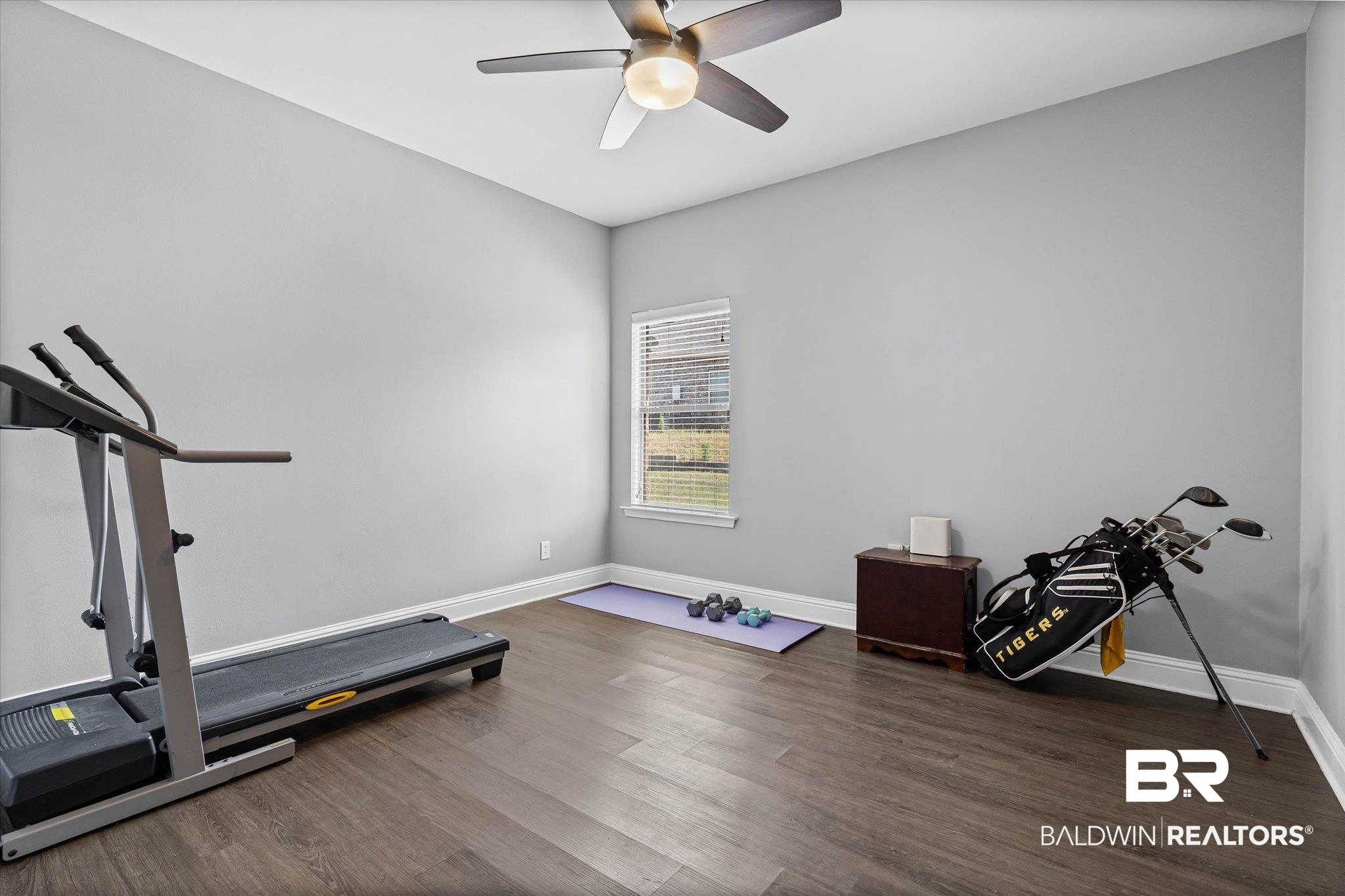 3739 Whitestone Drive Semmes, AL 36575 - Photo 18 of 25 Room featuring wood-finish flooring, light grey walls, and a white trim baseboard