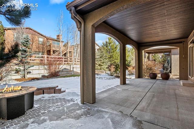 2464 Cinnabar Road Colorado Springs, CO 80921 - Photo 30 of 43 Snow covered patio featuring an outdoor fire pit