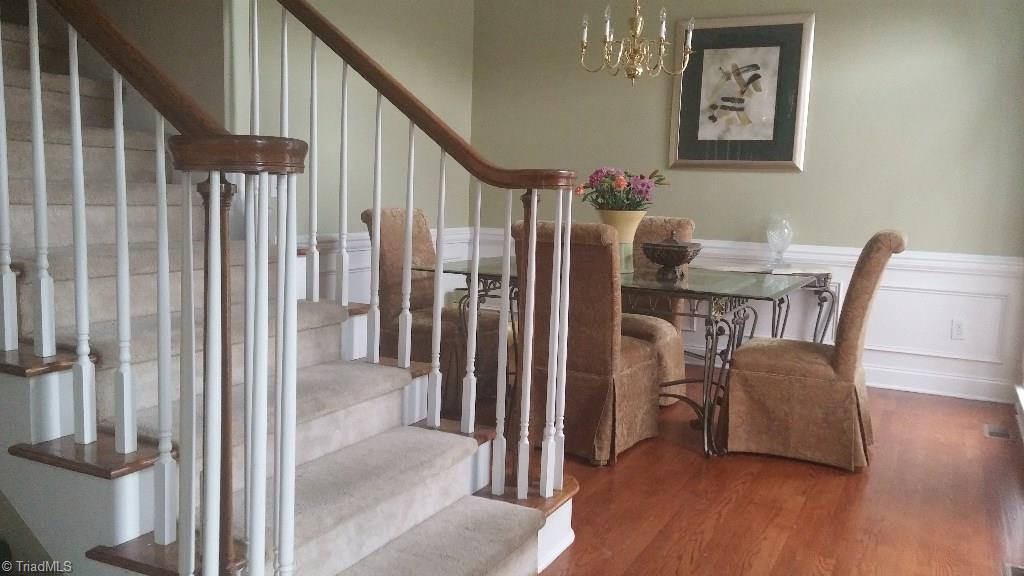 4910 Cade Road Climax, NC 27233 - Photo 2 of 13 Formal Dining room with hardwood floors which extend to foyer, hallway, family room and powder room. Trim out in chair rail molding.