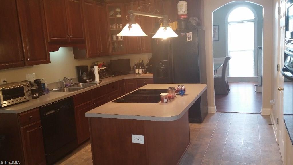 4910 Cade Road Climax, NC 27233 - Photo 6 of 13 Kitchen with island counter with overhang for bar stools. Please note the arched door way