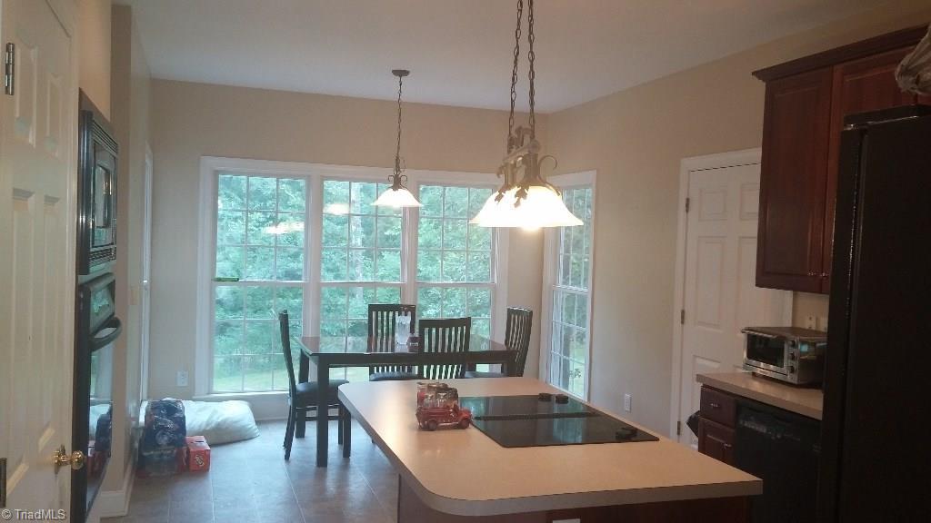 4910 Cade Road Climax, NC 27233 - Photo 7 of 13 Breakfast room with 3 sided windows.
