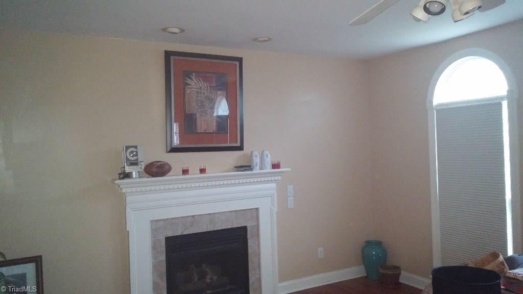 4910 Cade Road Climax, NC 27233 - Photo 8 of 13 Family room with decorative fireplace, recessed lighting and ceiling fan