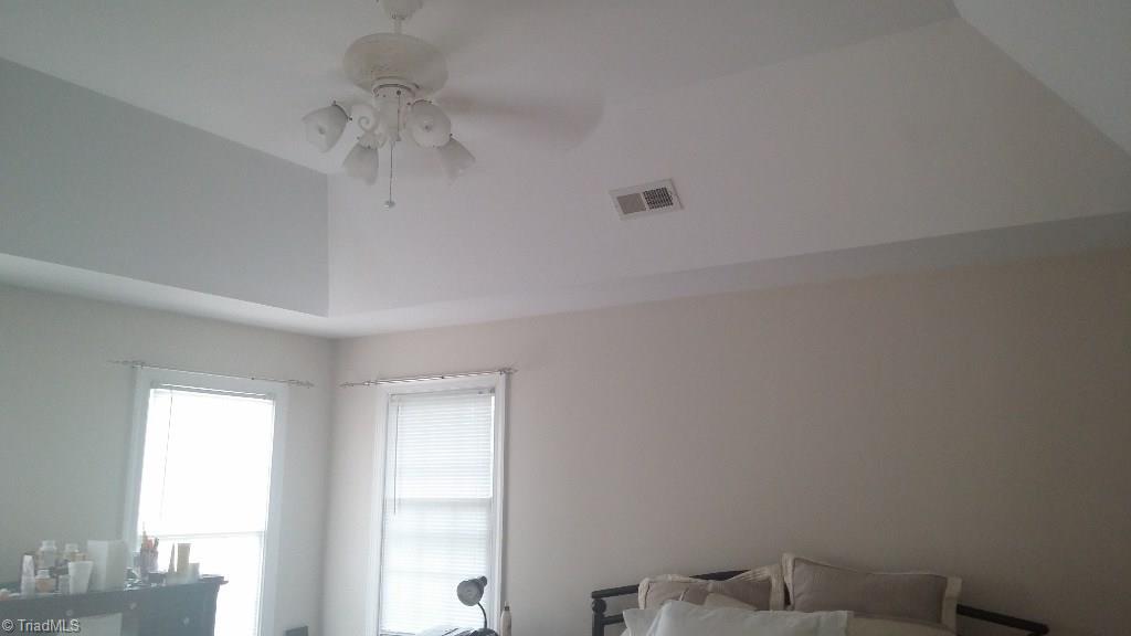 4910 Cade Road Climax, NC 27233 - Photo 10 of 13 Tray ceiling in master bedroom with ceiling fan.