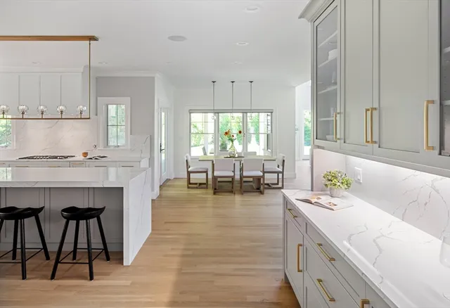 a kitchen with kitchen island stainless steel appliances a sink and cabinets