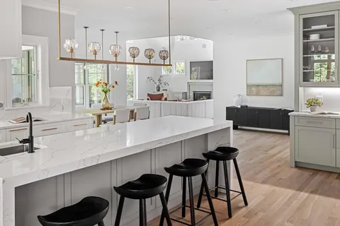 a living room with furniture a large window and a flat screen tv