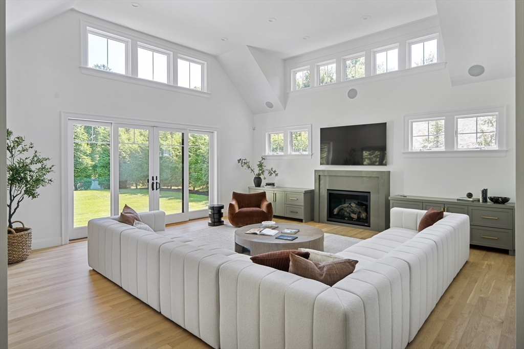 78 Pheasant Landing Road Needham, MA 02492 - Photo 14 of 35 a living room with furniture a large window and a flat screen tv