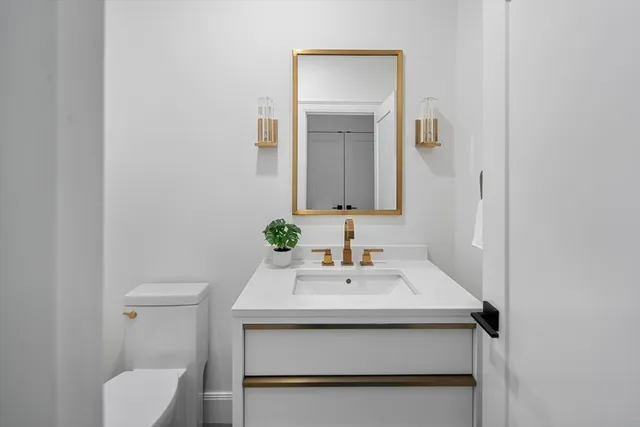 a spacious bedroom with a bed a couch and a chandelier