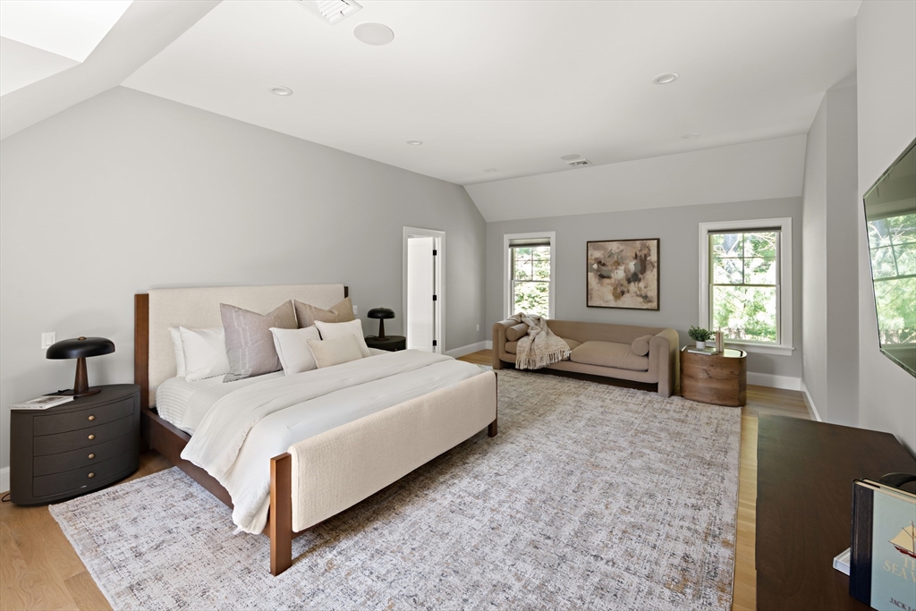 78 Pheasant Landing Road Needham, MA 02492 - Photo 16 of 35 a spacious bedroom with a bed a couch and a chandelier