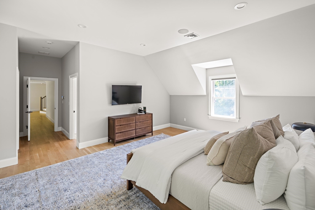 78 Pheasant Landing Road Needham, MA 02492 - Photo 17 of 35 a bedroom with a bed and a flat screen tv