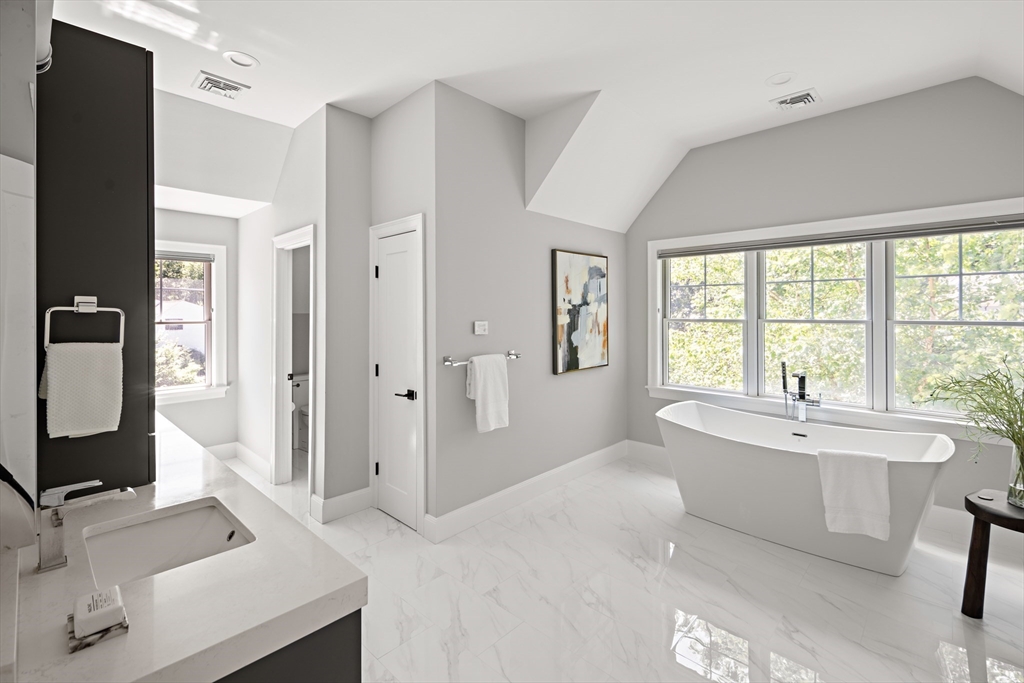 78 Pheasant Landing Road Needham, MA 02492 - Photo 19 of 35 a spacious bathroom with a bathtub sink and mirror